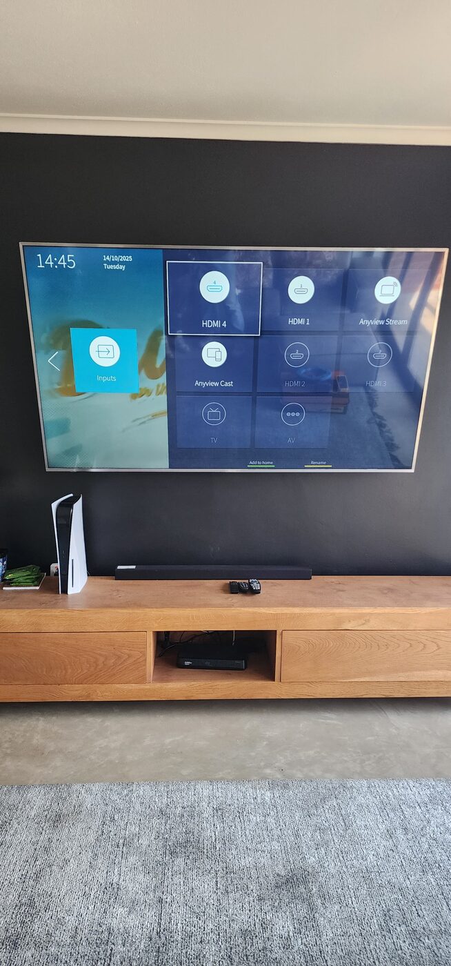 Finished DStv decoder and home theatre setup with tidy cabling under a mounted TV